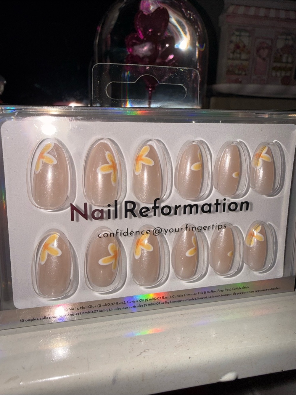 Nail Reformation beige press-on nails with yellow floral accents short almond